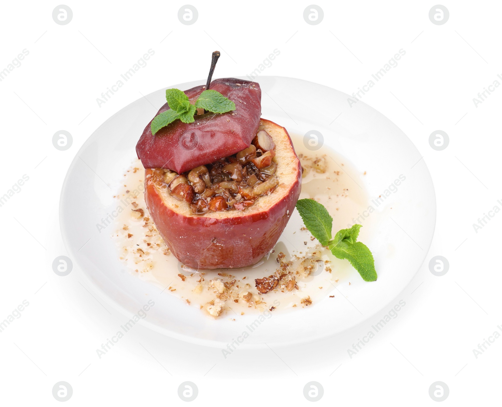 Photo of Tasty baked apple with nuts, honey and mint isolated on white