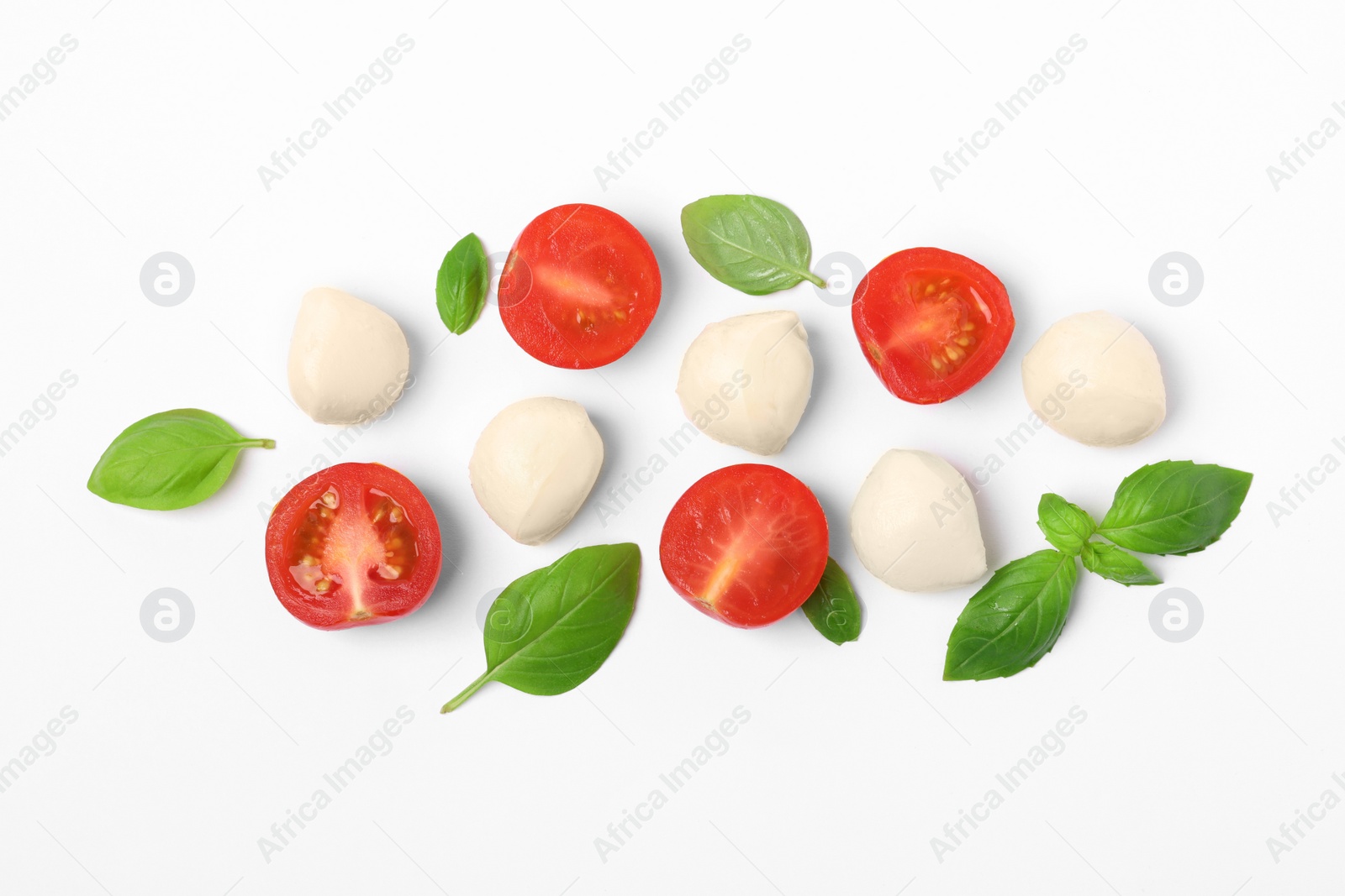 Photo of Mozzarella, tomatoes and basil on white background, flat lay. Caprese salad ingredients