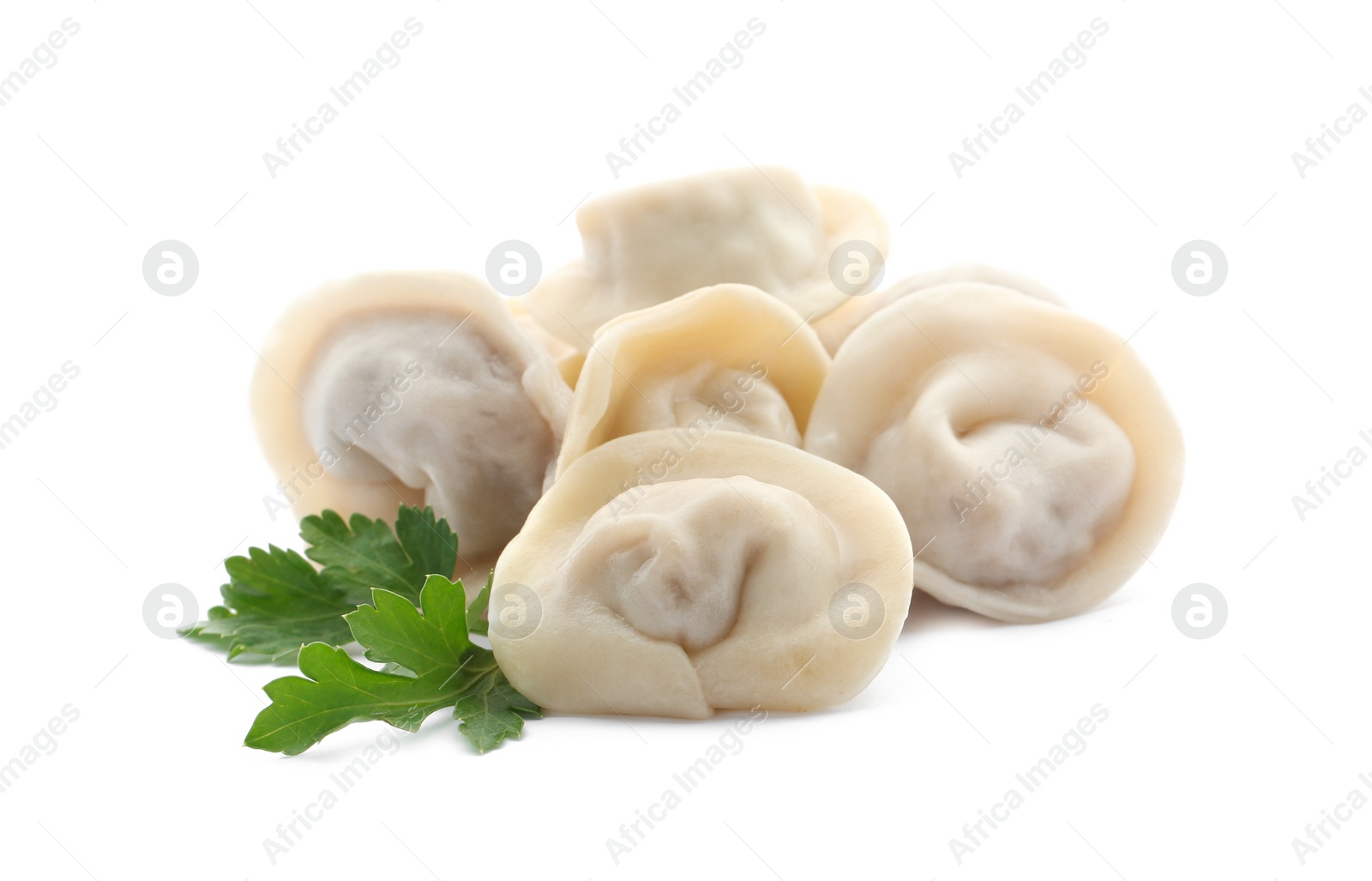 Photo of Pile of boiled dumplings with parsley leaves on white background