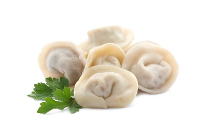 Photo of Pile of boiled dumplings with parsley leaves on white background