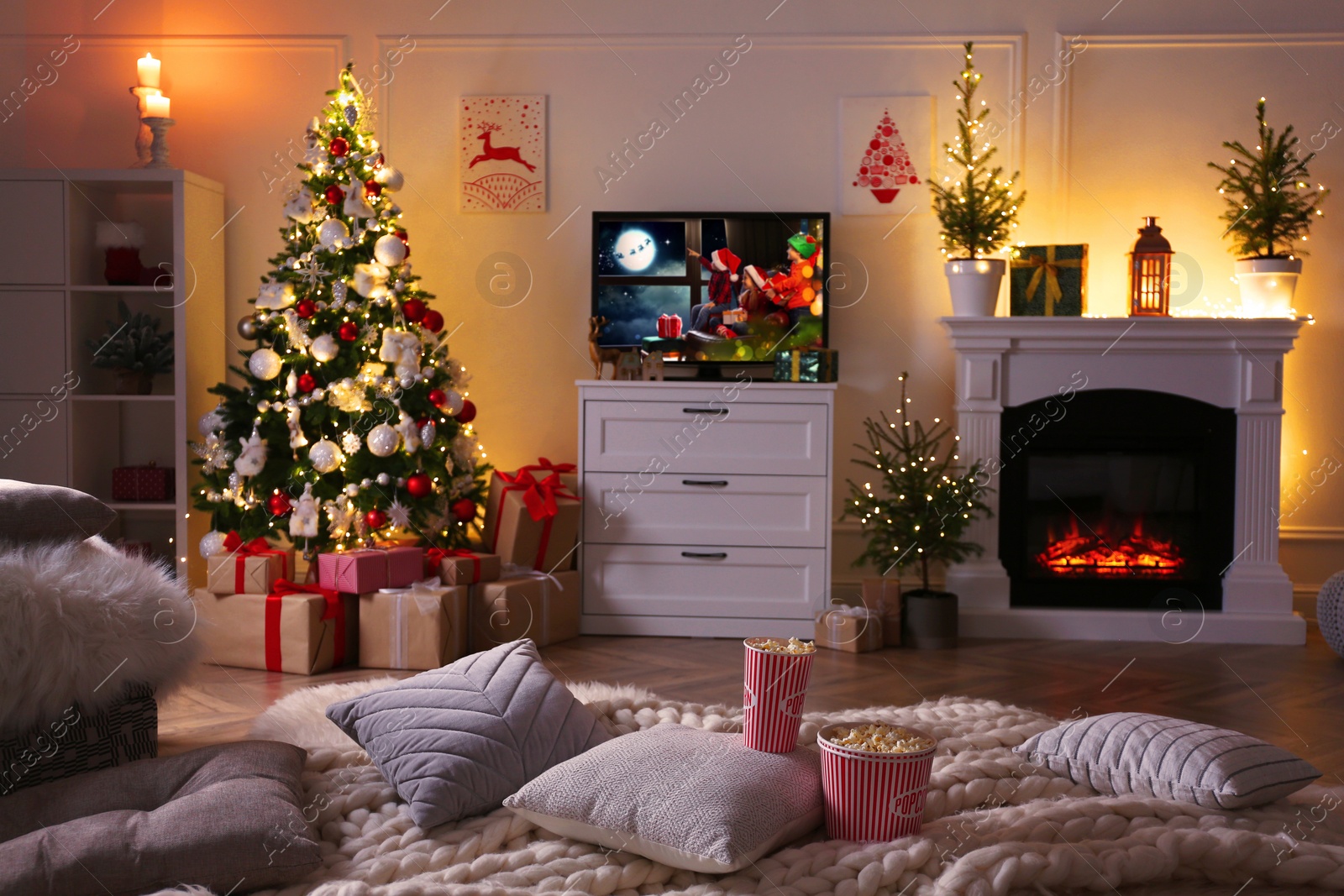 Image of Stylish living room interior with TV set, Christmas tree and fireplace