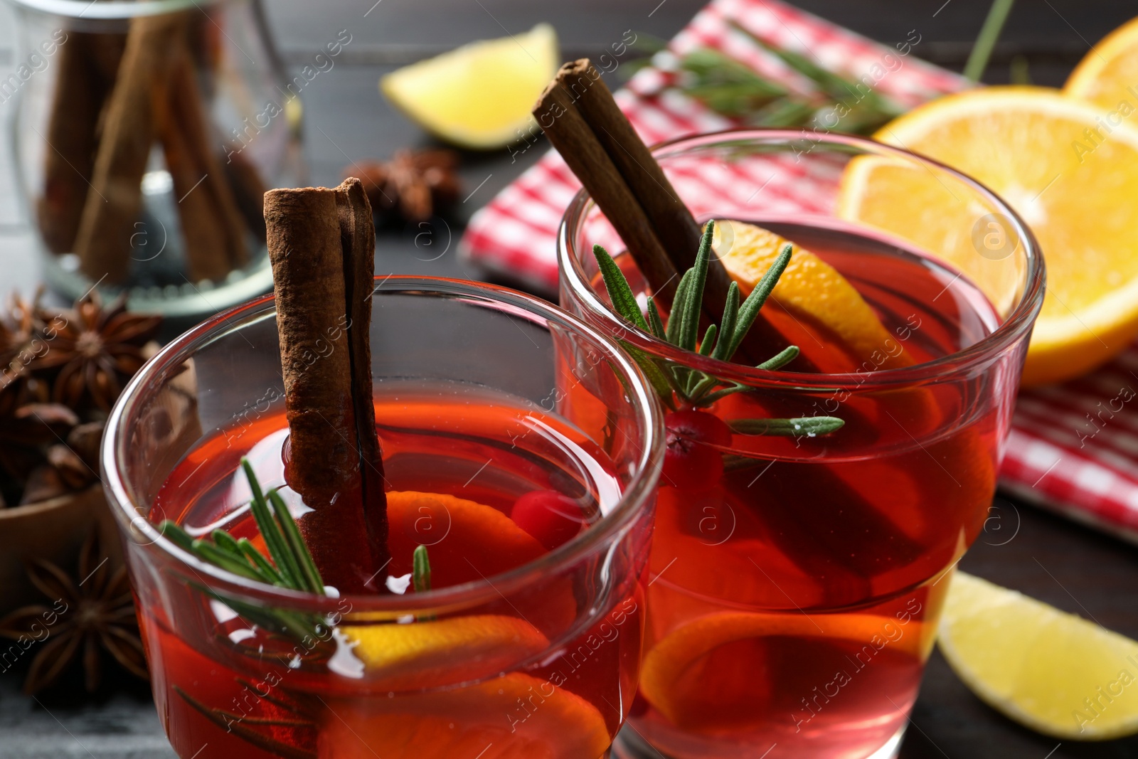 Photo of Glasses with aromatic punch drink on table, closeup