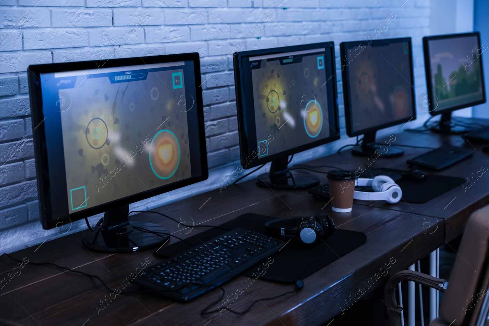 Photo of Internet cafe with modern computers for playing video games