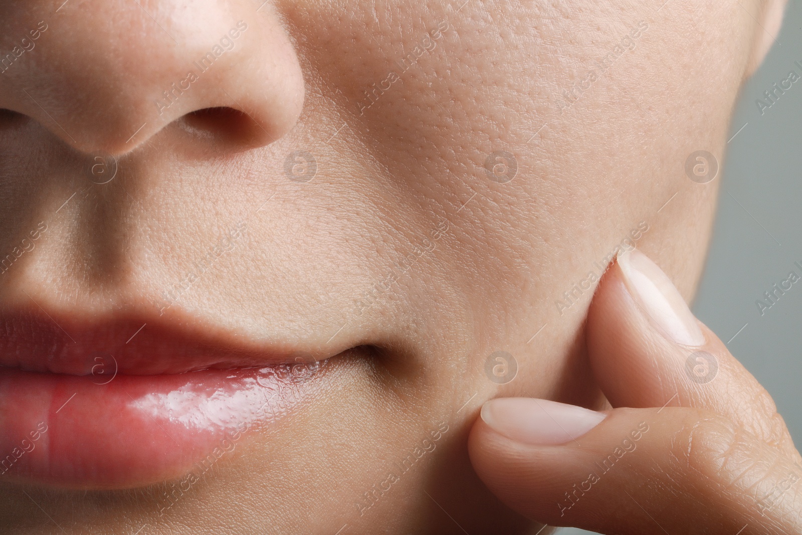 Photo of Closeup view of woman with healthy skin on light grey background