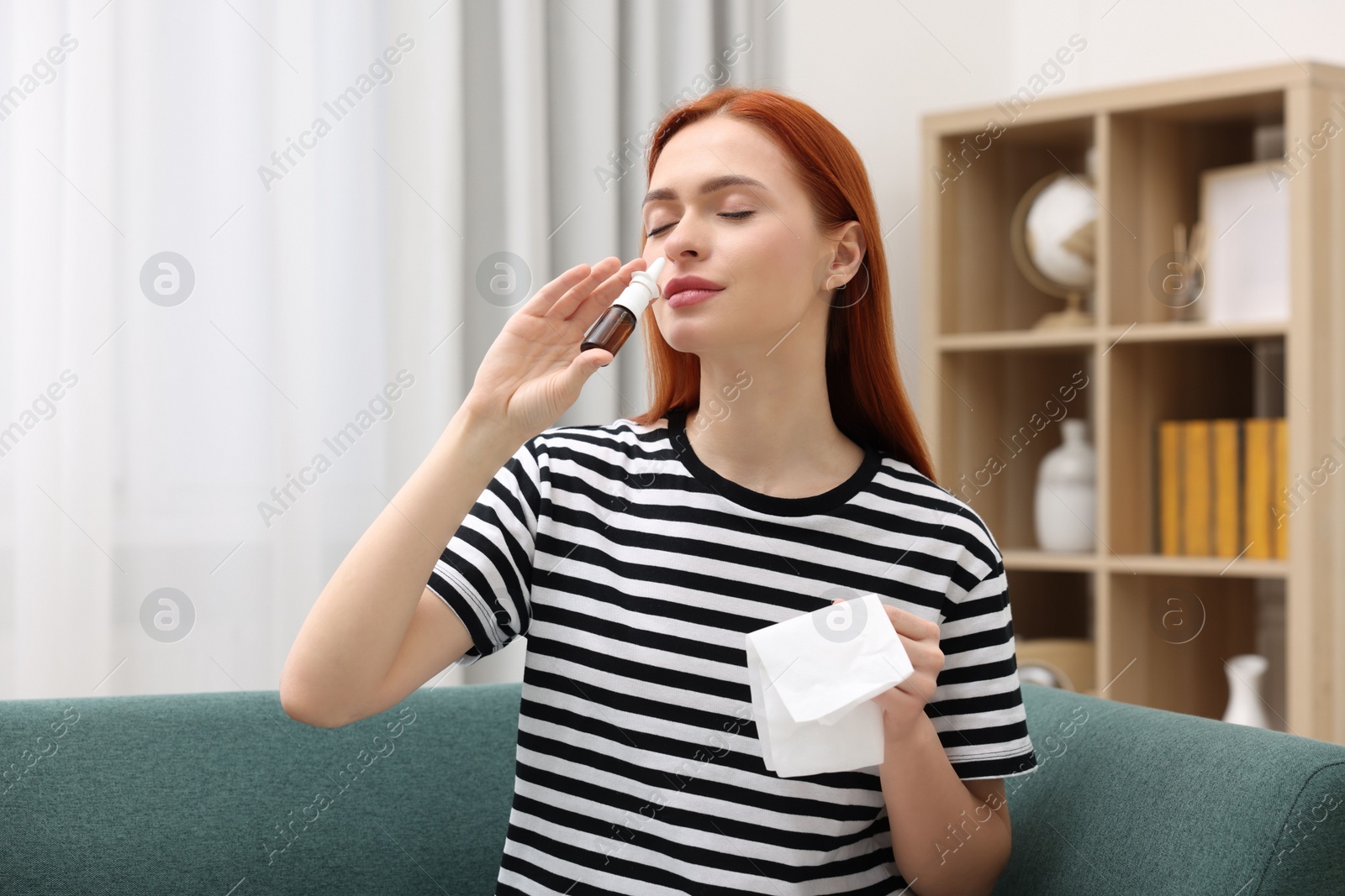 Photo of Medical drops. Woman with tissue using nasal spray at home