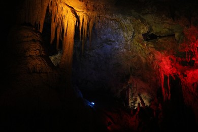 Photo of Picturesque view of many stalactite and stalagmite formations in cave