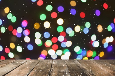 Image of Empty wooden surface and blurred Christmas lights on background, bokeh effect