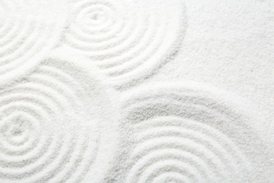 Photo of Zen rock garden. Circle patterns on white sand, closeup