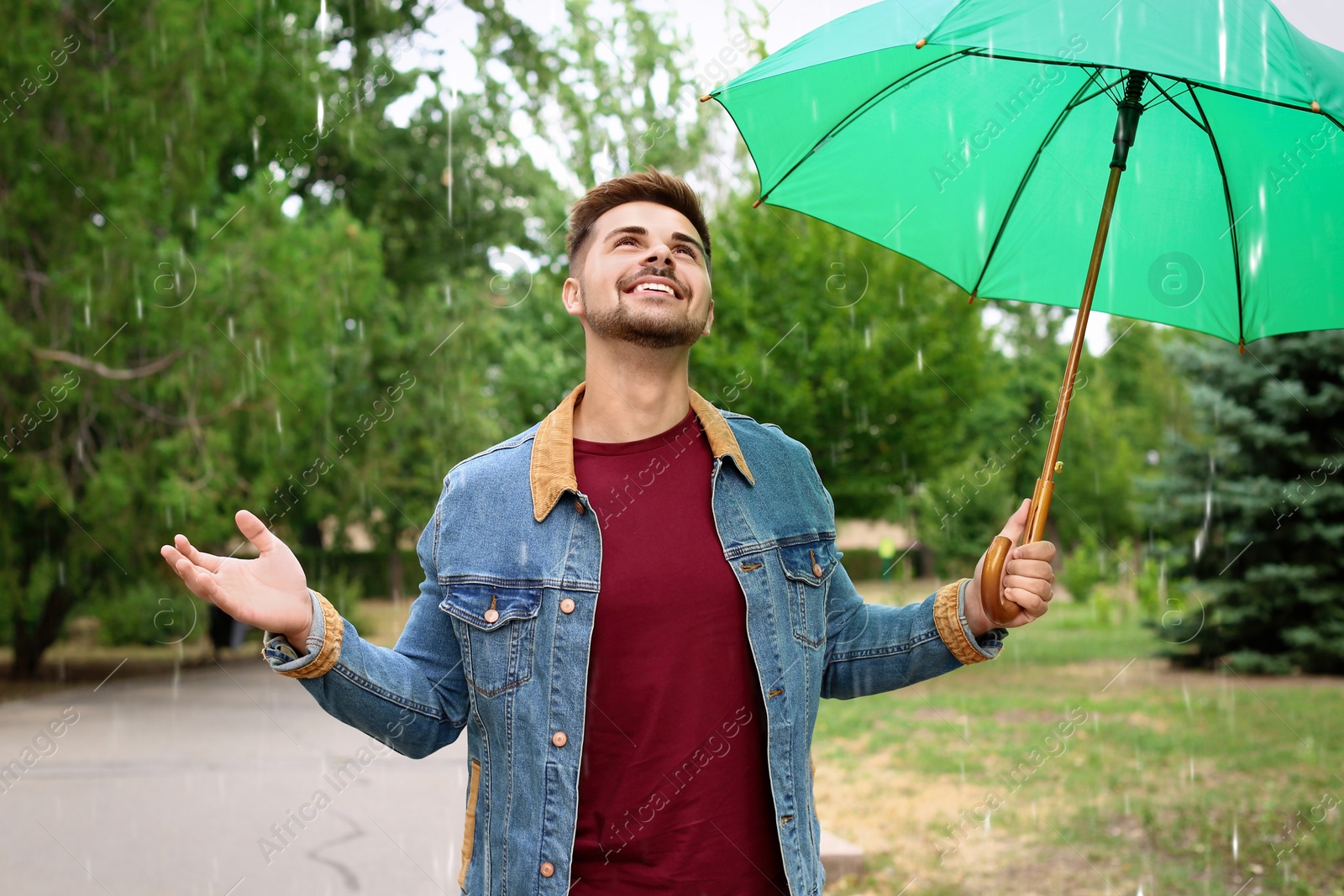 Photo of Man with umbrella outdoors on rainy day