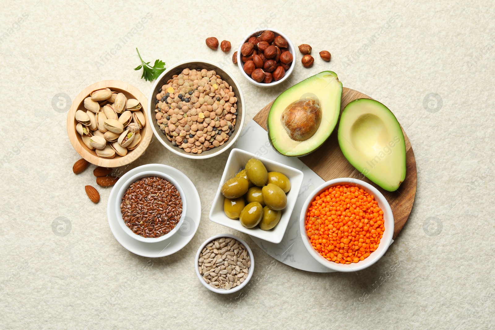 Photo of Different products high in natural fats on light table, flat lay