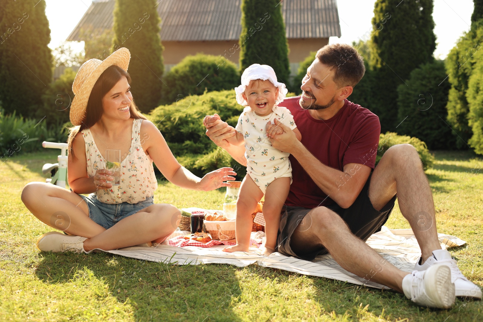 Photo of Happy family having picnic in garden on sunny day