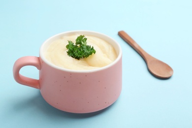 Photo of Bowl with tasty mashed potatoes on color background