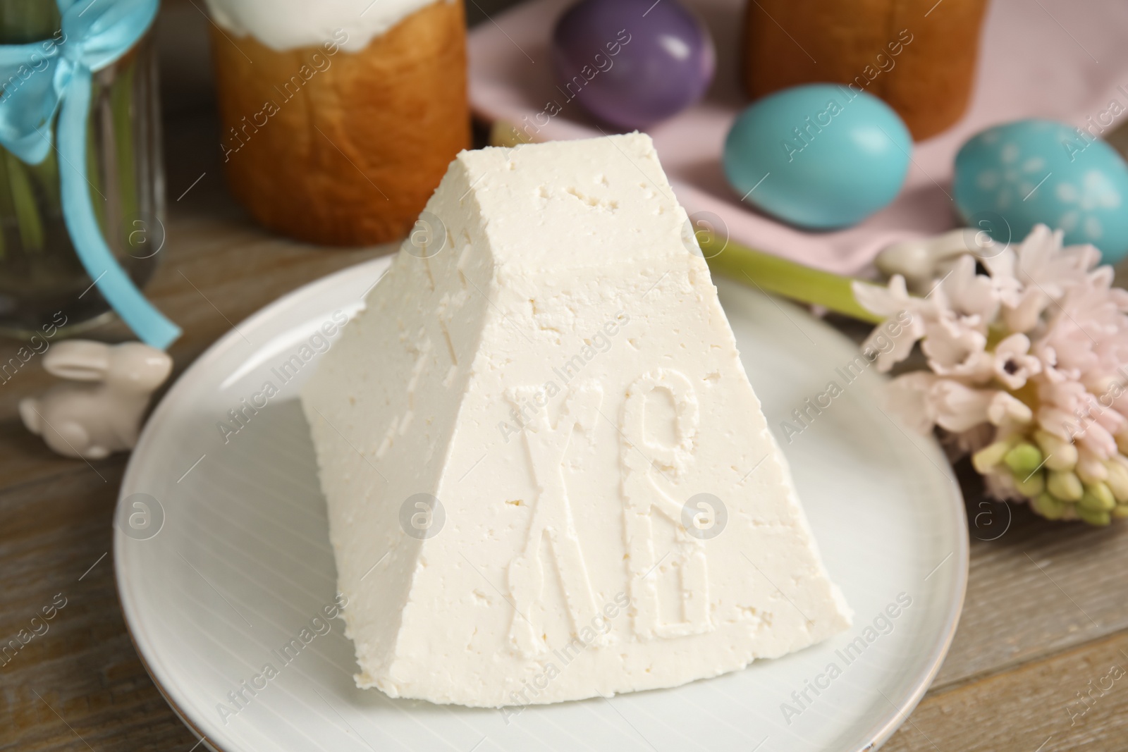 Photo of Traditional cottage cheese Easter paskha on wooden table, closeup