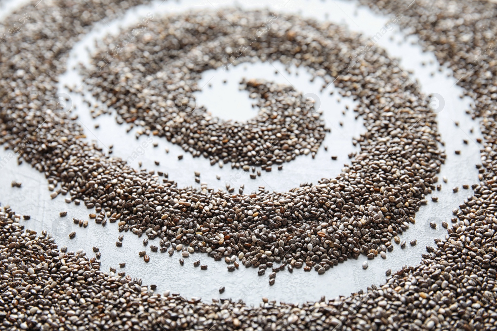 Photo of Chia seeds on grey background, closeup. Healthy eating