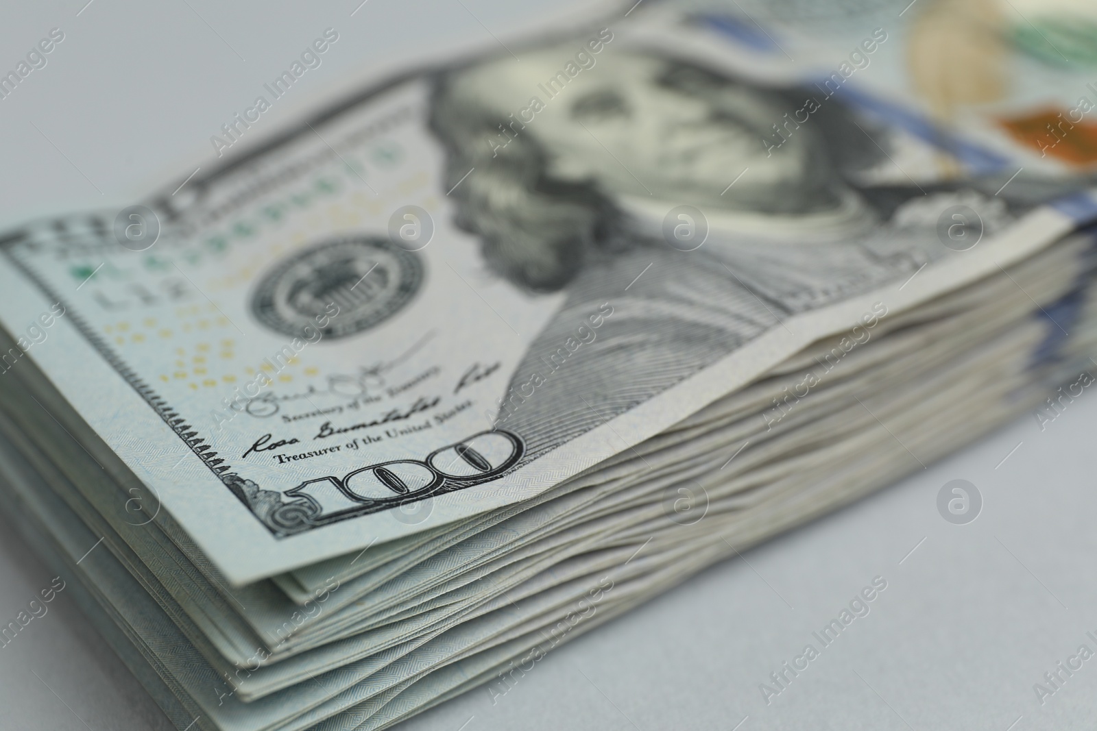Photo of Money exchange. Dollar banknotes on gray background, closeup