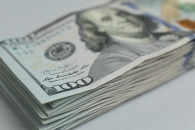 Photo of Money exchange. Dollar banknotes on gray background, closeup