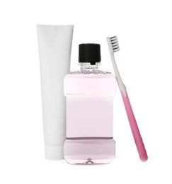 Photo of Bottle with mouthwash, toothbrush and paste on white background