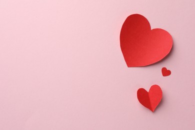 Photo of Paper hearts on pink background, flat lay. Space for text