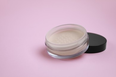 Photo of Loose face powder on pink background, space for text