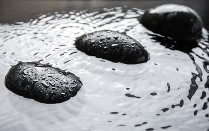 Spa stones in water, closeup. Zen lifestyle