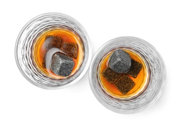 Glasses with liquor and whiskey stones on white background, top view