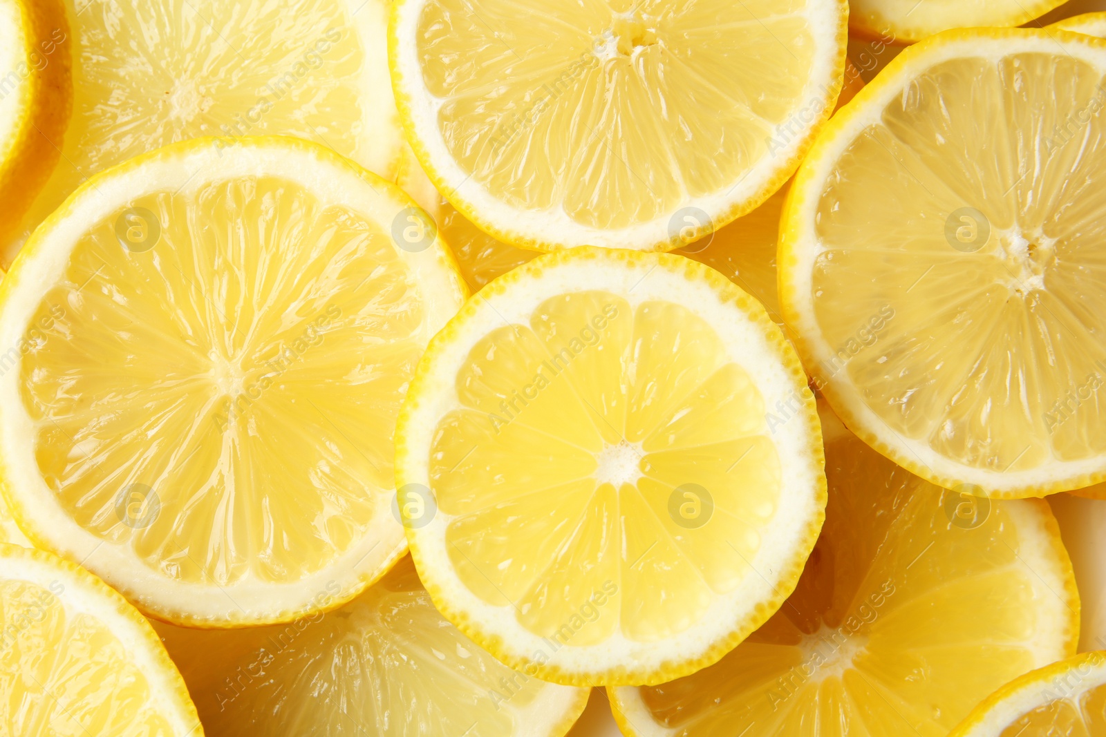 Photo of Many slices of fresh ripe lemons as background