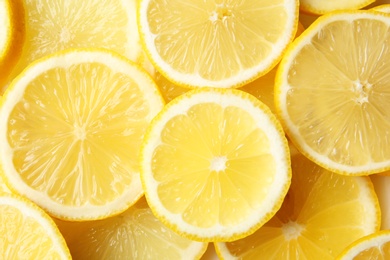 Photo of Many slices of fresh ripe lemons as background