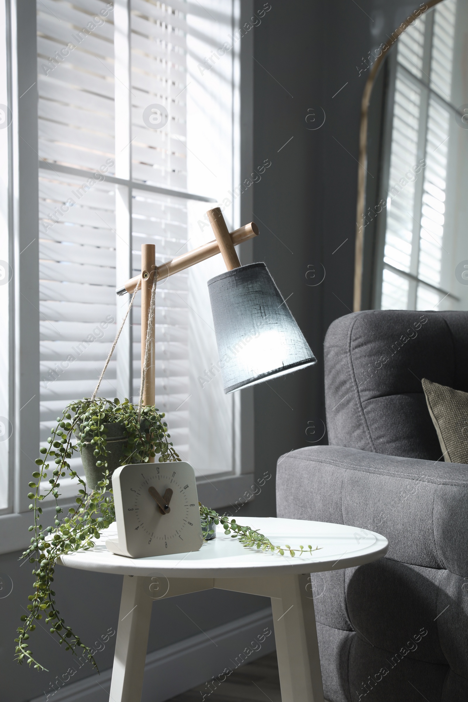 Photo of Room interior with stylish lamp and furniture