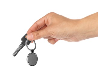 Woman holding key with metallic keychain on white background, closeup