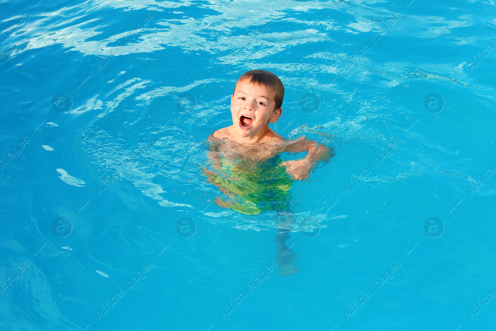 Photo of Little child in outdoor swimming pool. Dangerous situation