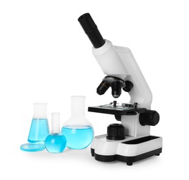 Laboratory glassware with light blue liquid and microscope isolated on white