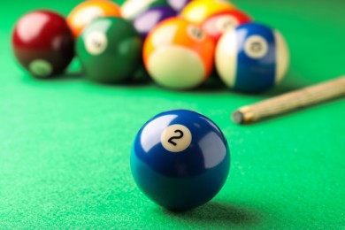 Billiard ball with number 2 on green table, closeup