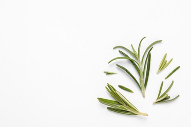 Photo of Sprigs of fresh rosemary on white background, flat lay. Space for text