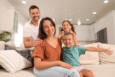 Photo of Portrait of happy family on sofa at home