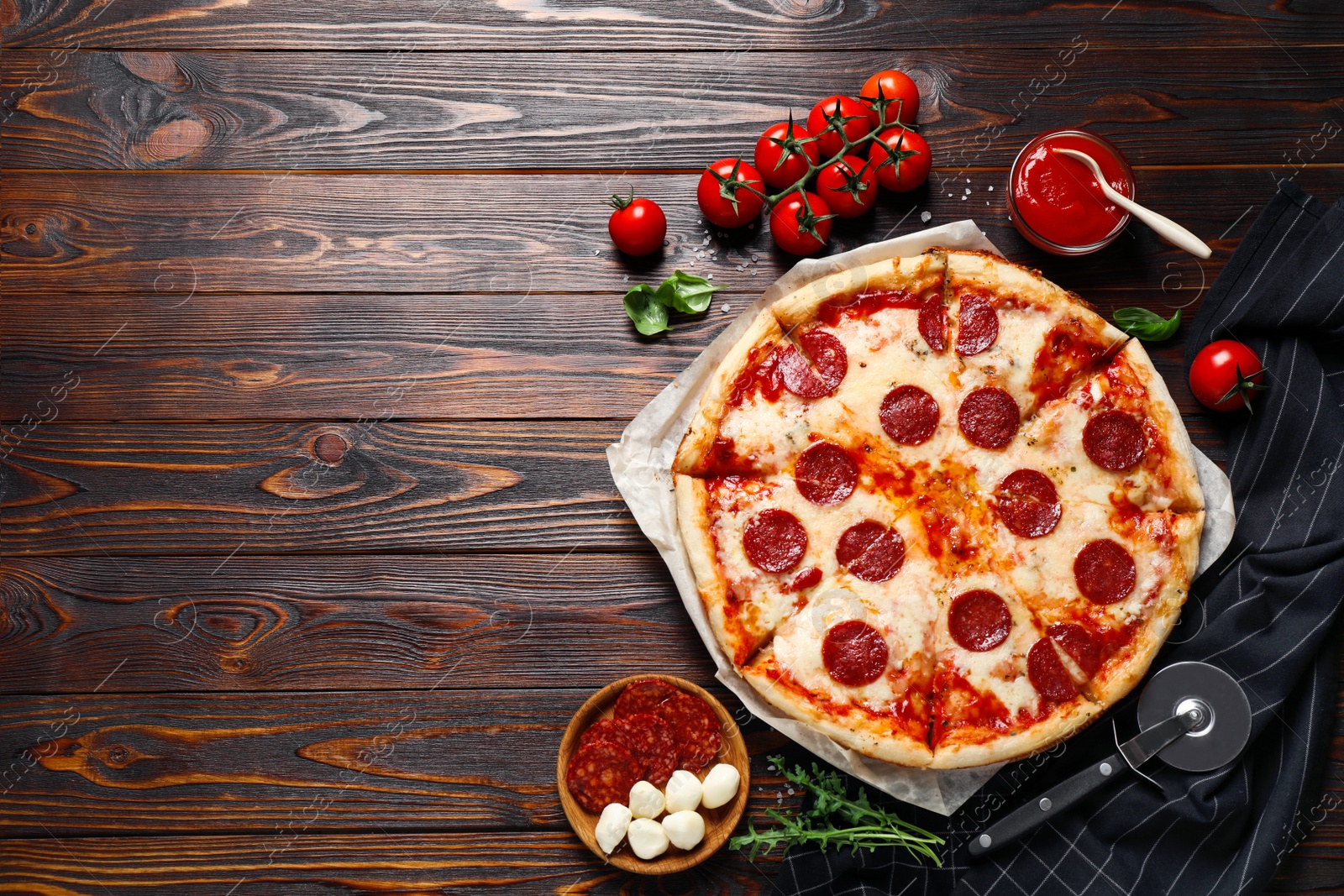 Photo of Flat lay composition with hot pepperoni pizza on wooden table. Space for text