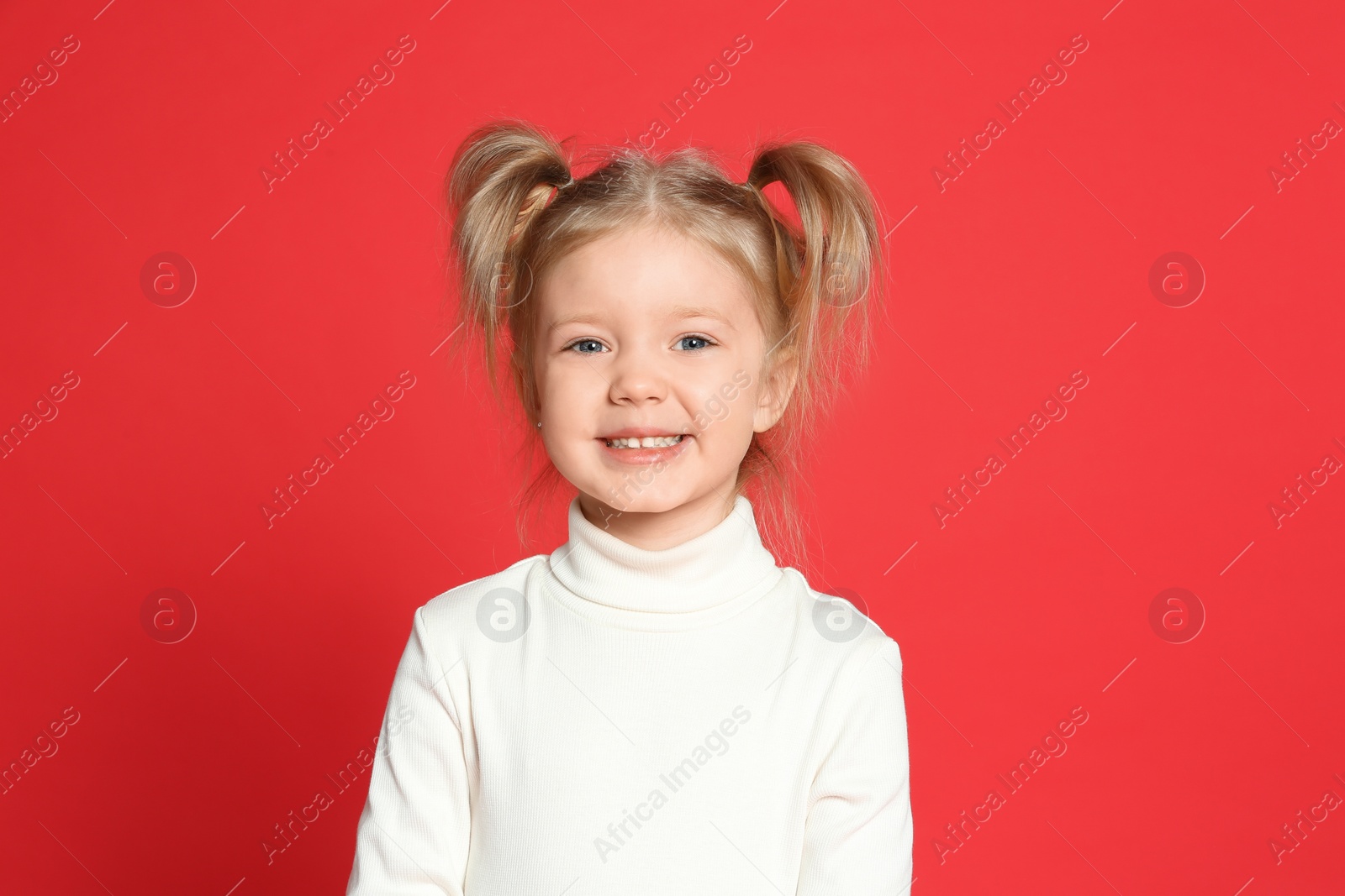 Photo of Portrait of cute little girl on red background