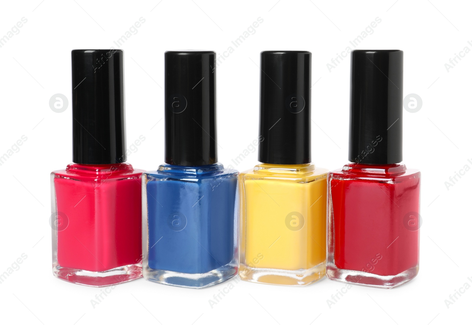 Photo of Bright nail polishes in bottles isolated on white