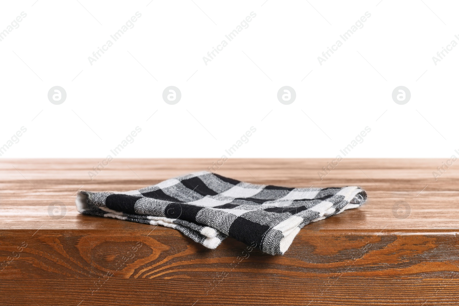 Photo of Checkered tablecloth on wooden table against white background