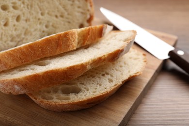 Photo of Cut tasty wheat sodawater bread on wooden table, closeup