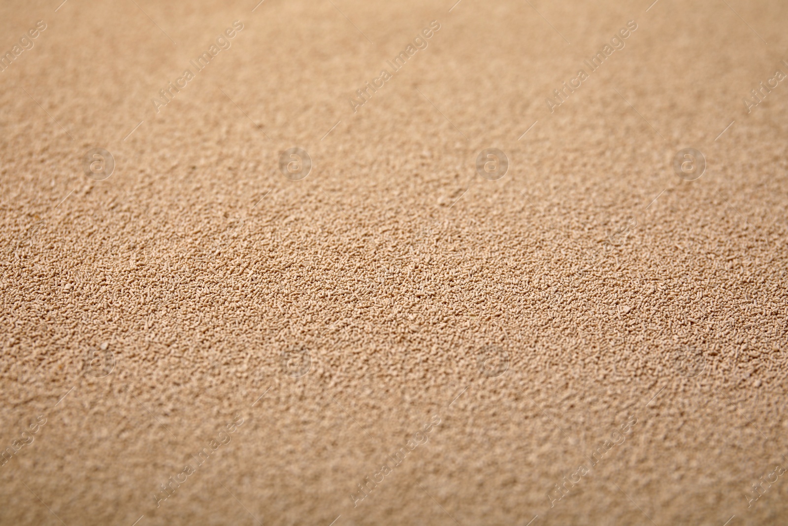 Photo of Granulated yeast as background, closeup view. Ingredient for baking