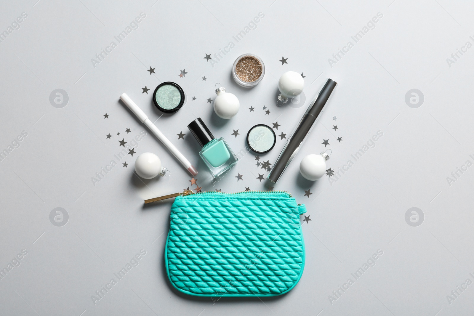 Photo of Flat lay composition with makeup products and Christmas decor on white background