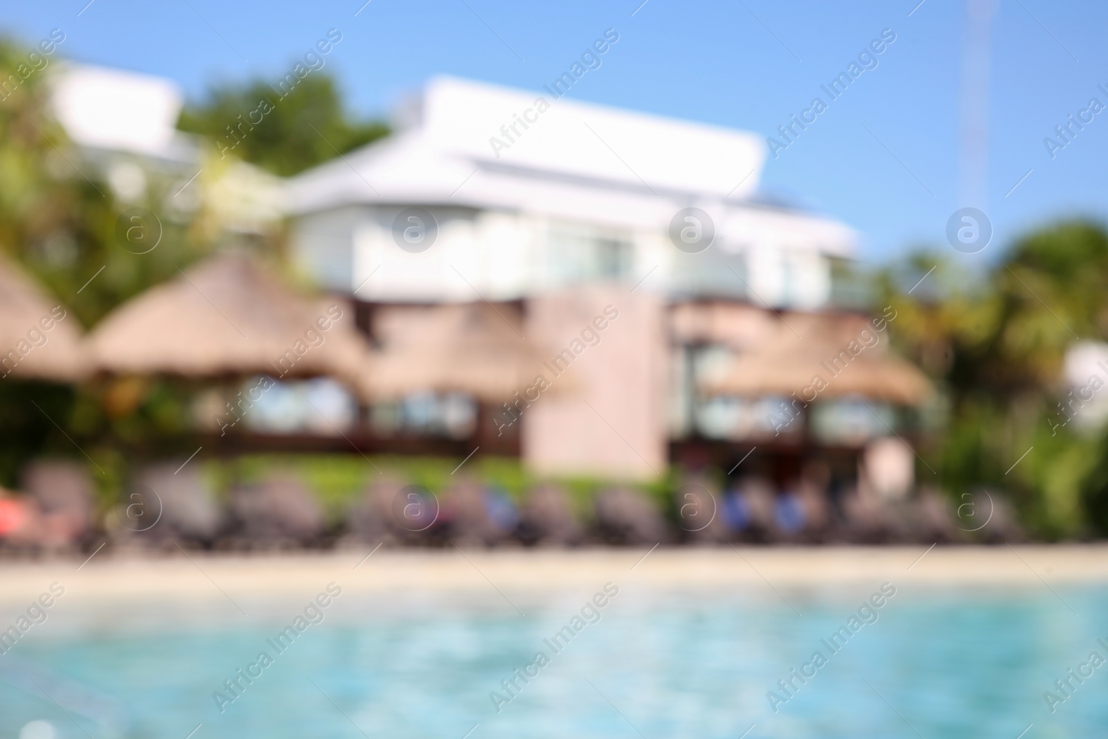 Photo of Blurred view of outdoor swimming pool at resort on sunny day