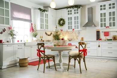 Small Christmas trees and festive decor in kitchen