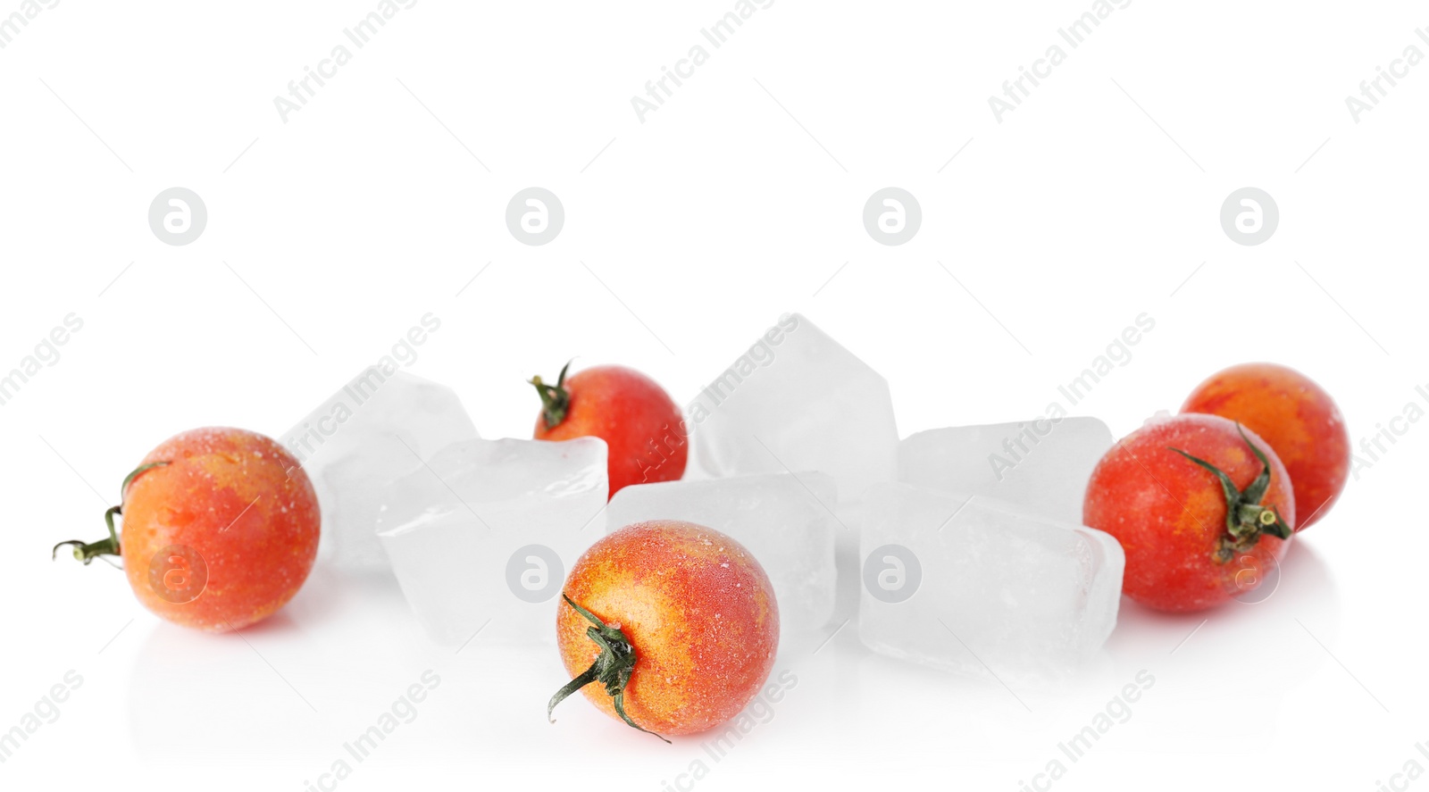 Photo of Frozen cherry tomatoes and ice cubes on white background. Keeping vegetables fresh