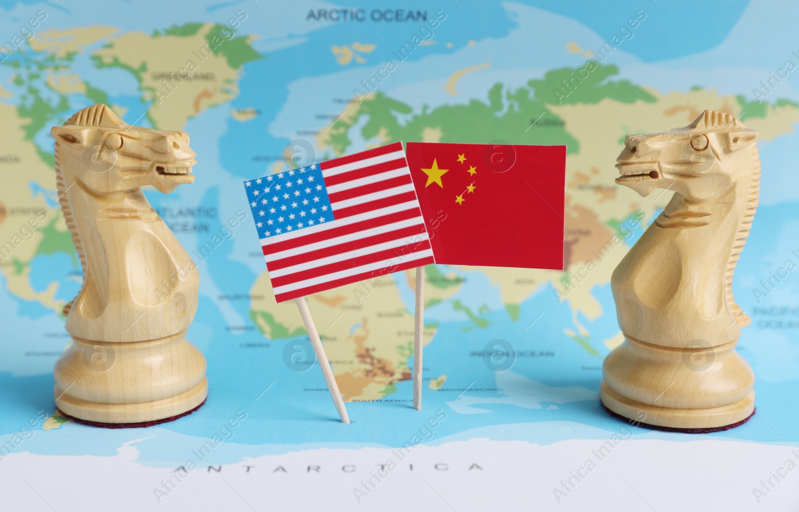 Photo of Chess pieces, American and Chinese flags on world map. Trade war concept