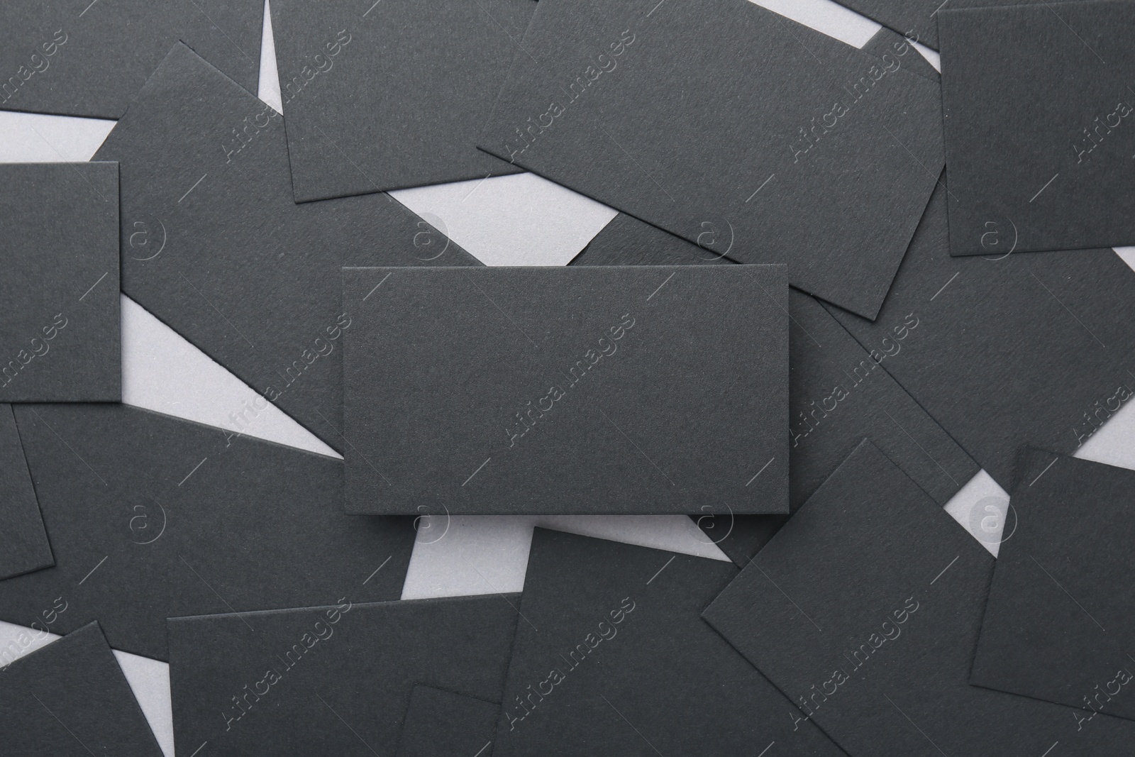Photo of Blank black business cards on table, flat lay. Mockup for design
