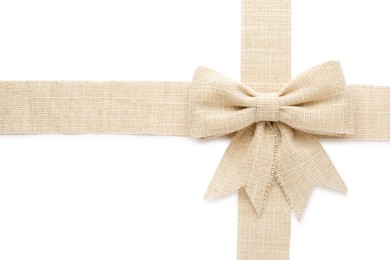 Photo of Burlap ribbons with pretty bow on white background, top view