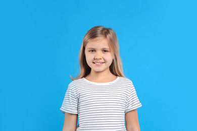 Photo of Cute little girl on light blue background