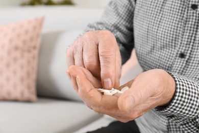 Photo of Senior man taking medicine, closeup. Health care