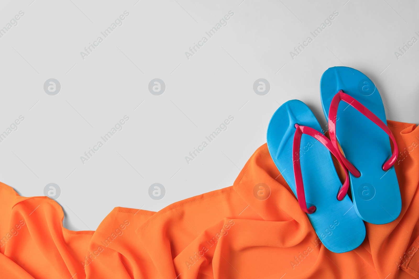 Photo of Flat lay composition with beach accessories on white background, space for text